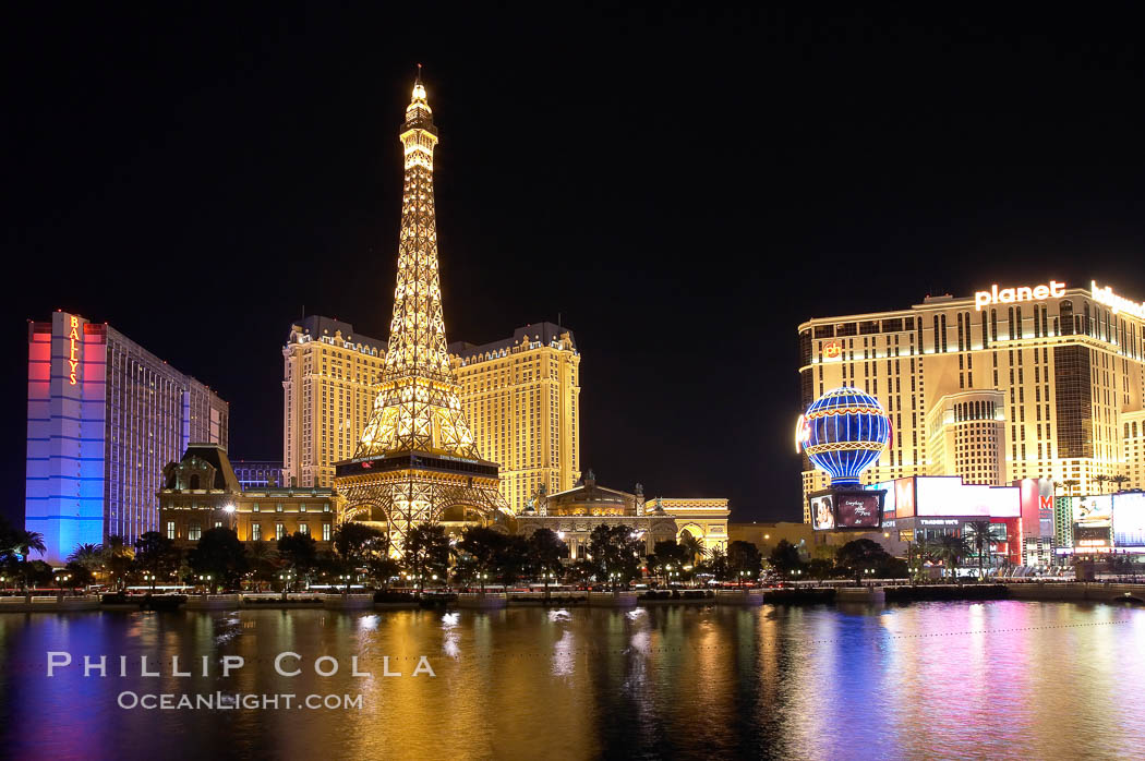 The half-scale replica of the Eiffel Tower at the Paris Hotel in Las Vegas is reflected in the Bellagio Hotel fountain pool at night. Nevada, USA, natural history stock photograph, photo id 20577