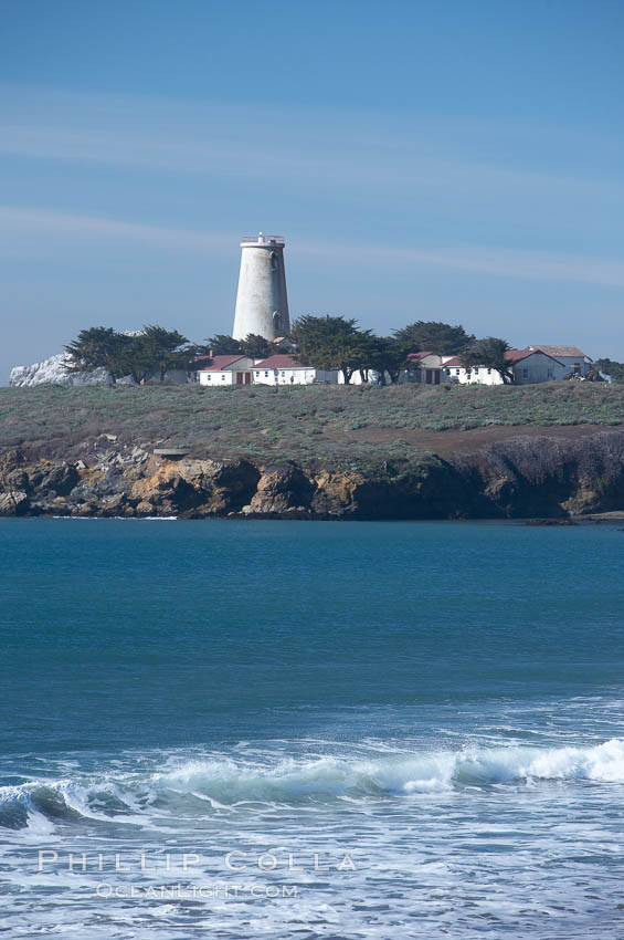 Piedras Blancas lighthouse.  Completed in 1875, the 115-foot-tall Piedras Blancas lighthouse is one of the few tall-style lighthouses on the West Coast of the United States.  Piedras Blancas, named for a group of three white rocks just offshore, is north of San Simeon, California very close to Hearst Castle. USA, natural history stock photograph, photo id 20354