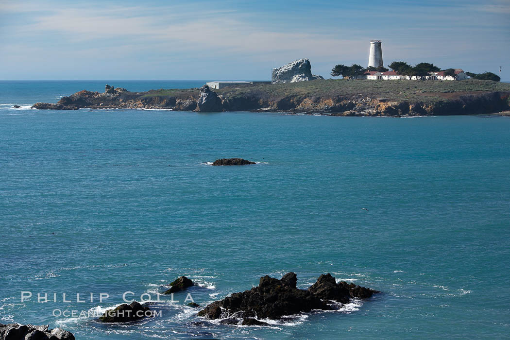 Piedras Blancas lighthouse.  Completed in 1875, the 115-foot-tall Piedras Blancas lighthouse is one of the few tall-style lighthouses on the West Coast of the United States.  Piedras Blancas, named for a group of three white rocks just offshore, is north of San Simeon, California very close to Hearst Castle. USA, natural history stock photograph, photo id 20352