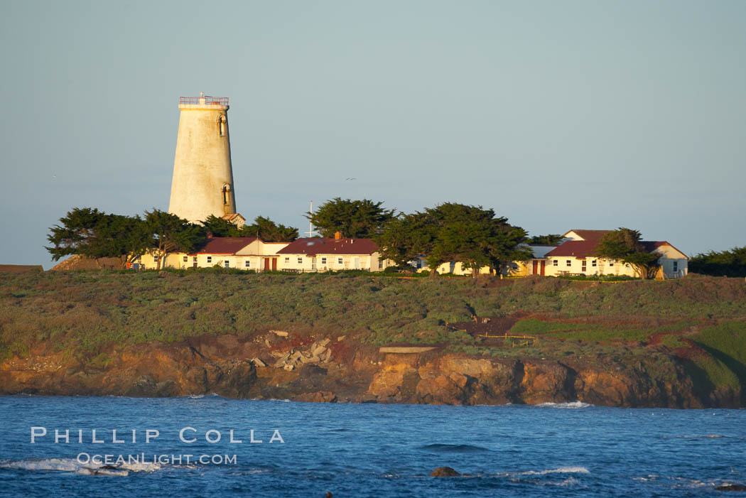 Piedras Blancas lighthouse.  Completed in 1875, the 115-foot-tall Piedras Blancas lighthouse is one of the few tall-style lighthouses on the West Coast of the United States.  Piedras Blancas, named for a group of three white rocks just offshore, is north of San Simeon, California very close to Hearst Castle. USA, natural history stock photograph, photo id 15655