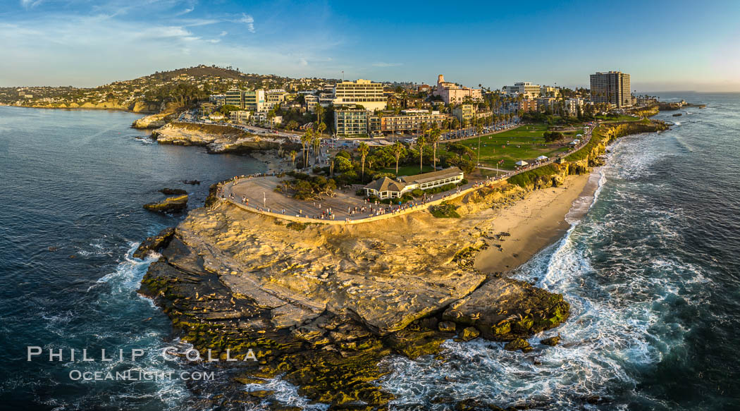 Point La Jolla and Scripps Park aerial photo, sunset, sea lions and sea gulls and tourists looking down on Boomer Beach. Aerial panoramic photo