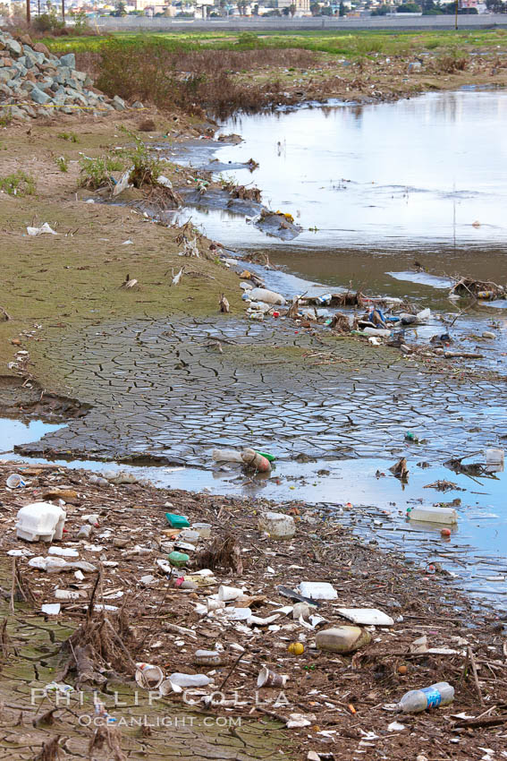 Pollution accumulates in the Tijuana River Valley following winter storms which flush the trash from Tijuana in Mexico across the border into the United States. Imperial Beach, San Diego, California, USA, natural history stock photograph, photo id 22545