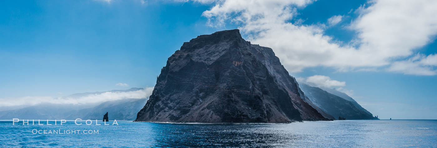 Punta Norte, the northern point of Guadalupe Island, viewed from the north.  Punta Desfiladero (Blunt Point) and Roca Elefante are just visible at far right, and Roca Piloto (Pilot Rock) is see to the left of the island against the distant sweep of the cliffs that comprise the northeastern bight of the island, actually the rim of an enormous caldera. Guadalupe Island (Isla Guadalupe), Baja California, Mexico, natural history stock photograph, photo id 28760