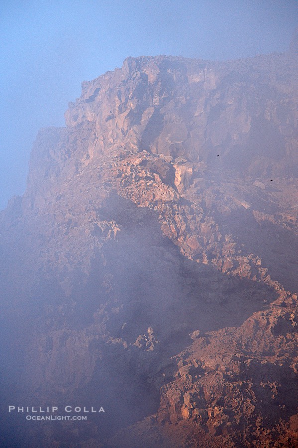 Red volcanic cliffs and fog, sunrise, Guadalupe Island., natural history stock photograph, photo id 21356