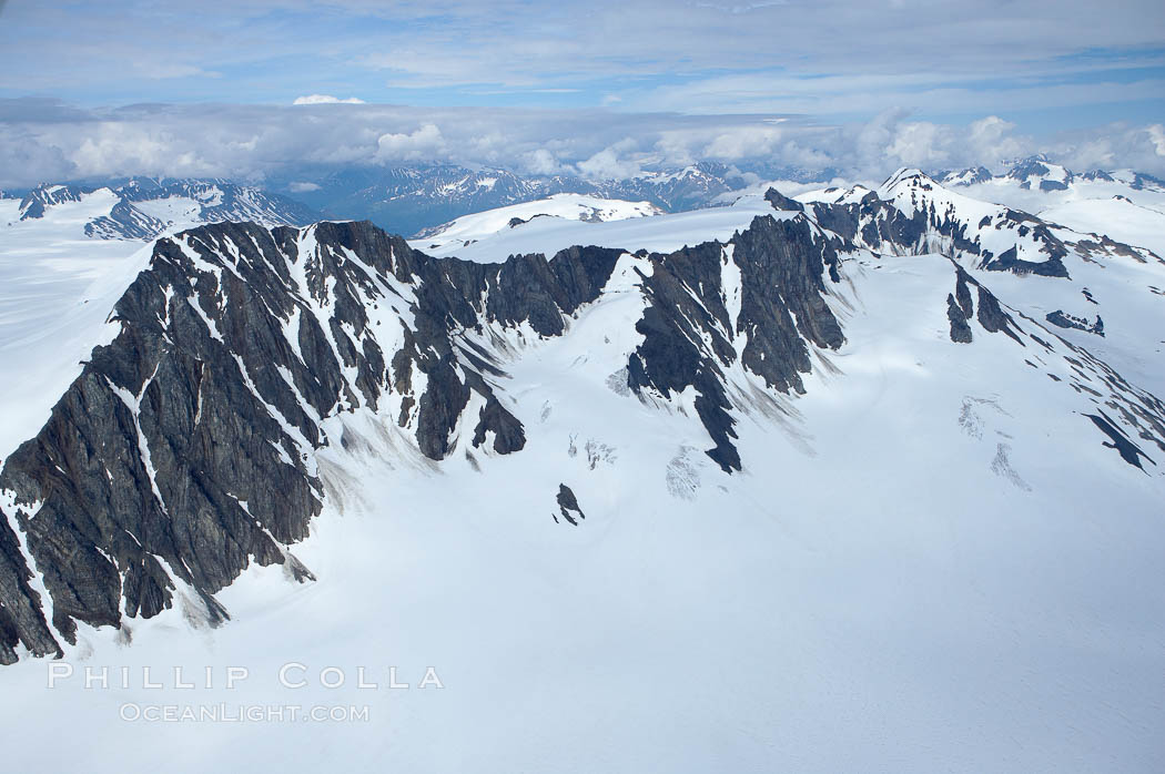 The Kenai Mountains rise above thick ice sheets and the Harding Icefield which is one of the largest icefields in Alaska and gives rise to over 30 glaciers. Kenai Fjords National Park, USA, natural history stock photograph, photo id 19026