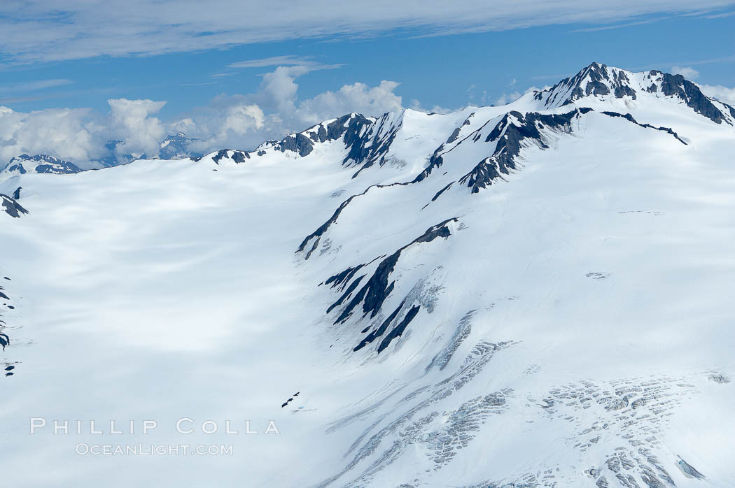 The Kenai Mountains rise above thick ice sheets and the Harding Icefield which is one of the largest icefields in Alaska and gives rise to over 30 glaciers. Kenai Fjords National Park, USA, natural history stock photograph, photo id 19034