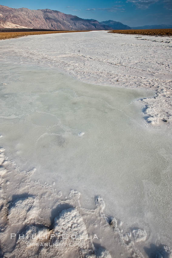 A river of salt flows across Death Valley, toward the lowest point in the United States at Badwater. Death Valley National Park, California, USA, natural history stock photograph, photo id 25260