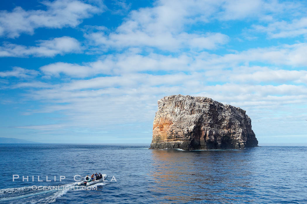 An inflatable boat full of adventurous divers heads towards Roca Redonda (round rock), a lonely island formed from volcanic forces, in the western part of the Galapagos archipelago. Galapagos Islands, Ecuador, natural history stock photograph, photo id 16642