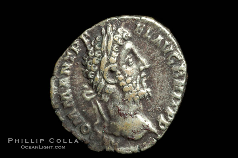 Roman emperor Commodus (177-192 A.D.), depicted on ancient Roman coin (silver, denom/type: Denarius) (AR , Denarius Obverse: M.COMM.ANT.P.FEL.AVG.BRIT.PP. Reverse: GEN.AVG.FLIC.COS.VI.  Genius standing left sacrificing scepter from a patera over an alter.)., natural history stock photograph, photo id 06797