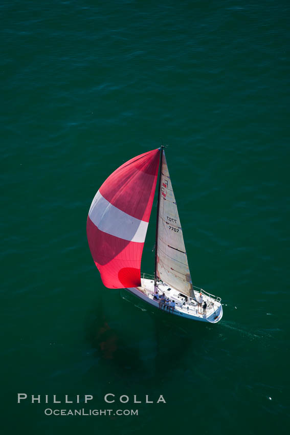 Sailboat under sail on the open ocean, spinnaker set and filled with wind., natural history stock photograph, photo id 26031