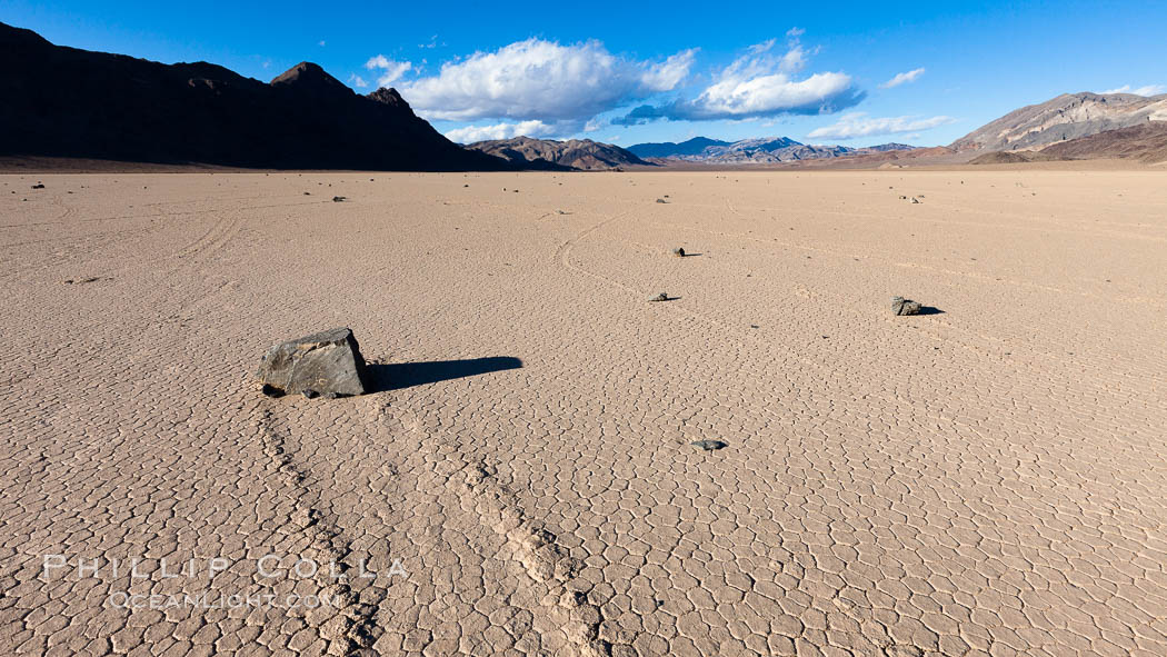 Sailing stone on the Racetrack Playa. The sliding rocks, or sailing stones, move across the mud flats of the Racetrack Playa, leaving trails behind in the mud. The explanation for their movement is not known with certainty, but many believe wind pushes the rocks over wet and perhaps icy mud in winter. Death Valley National Park, California, USA, natural history stock photograph, photo id 27687