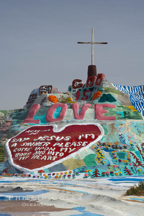 Salvation Mountain, near the desert community of Slab City and the small town of Niland on the east side of the Salton Sea.  Built over several decades by full-time resident Leonard Knight, who lives at the site, Salvation Mountain was built from over 100,000 gallons of paint, haybales, wood and metal and was created by Mr. Knight to convey the message that "God Loves Everyone". California, USA, natural history stock photograph, photo id 22510