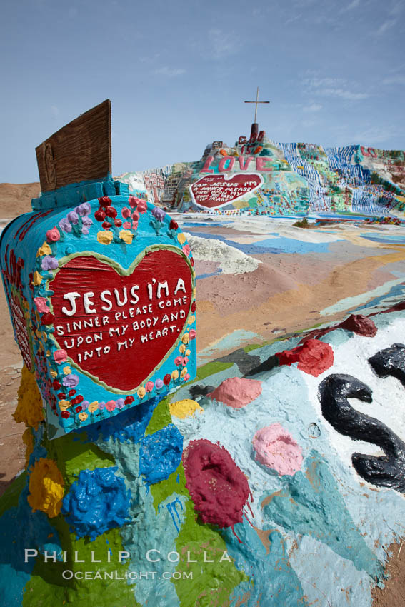 Salvation Mountain, near the desert community of Slab City and the small town of Niland on the east side of the Salton Sea.  Built over several decades by full-time resident Leonard Knight, who lives at the site, Salvation Mountain was built from over 100,000 gallons of paint, haybales, wood and metal and was created by Mr. Knight to convey the message that "God Loves Everyone". California, USA, natural history stock photograph, photo id 22514