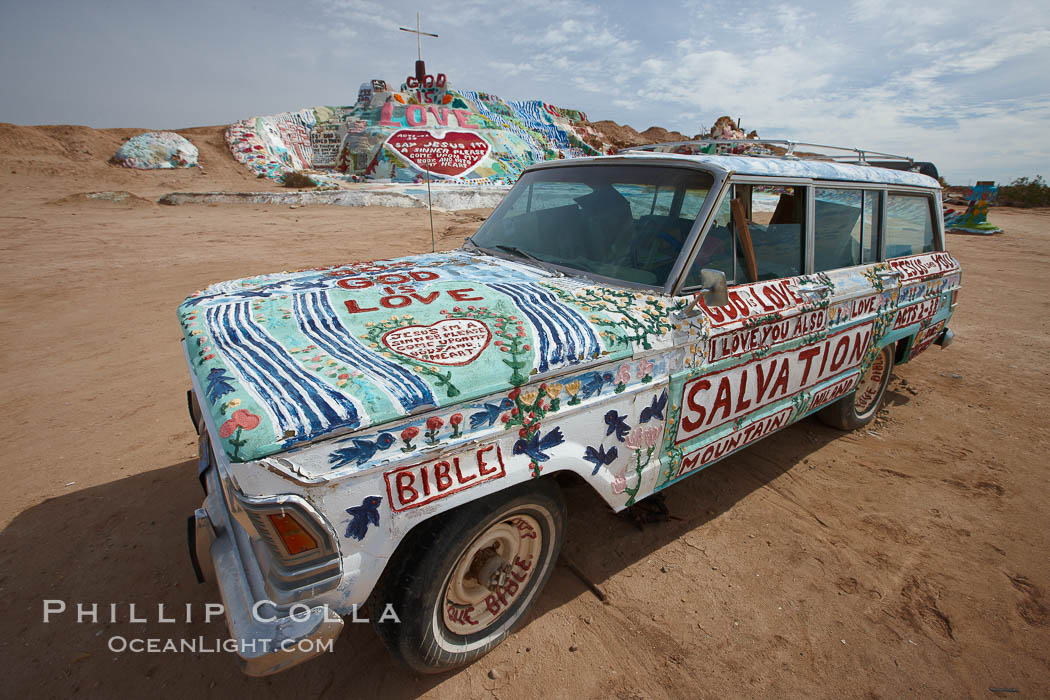 Salvation Mountain, near the desert community of Slab City and the small town of Niland on the east side of the Salton Sea.  Built over several decades by full-time resident Leonard Knight, who lives at the site, Salvation Mountain was built from over 100,000 gallons of paint, haybales, wood and metal and was created by Mr. Knight to convey the message that "God Loves Everyone". California, USA, natural history stock photograph, photo id 22508