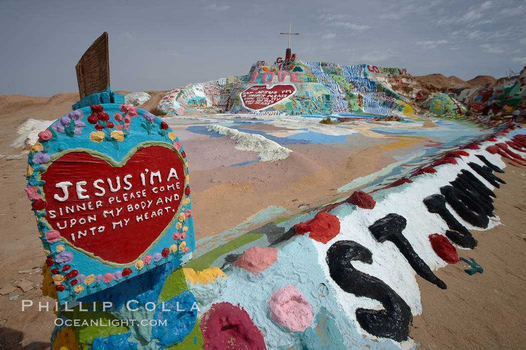 Salvation Mountain, near the desert community of Slab City and the small town of Niland on the east side of the Salton Sea.  Built over several decades by full-time resident Leonard Knight, who lives at the site, Salvation Mountain was built from over 100,000 gallons of paint, haybales, wood and metal and was created by Mr. Knight to convey the message that "God Loves Everyone". California, USA, natural history stock photograph, photo id 22507