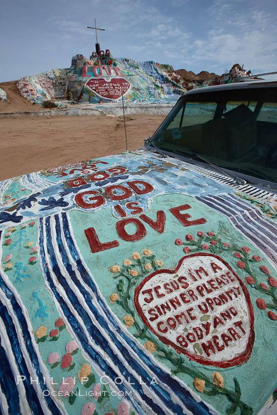 Salvation Mountain, near the desert community of Slab City and the small town of Niland on the east side of the Salton Sea.  Built over several decades by full-time resident Leonard Knight, who lives at the site, Salvation Mountain was built from over 100,000 gallons of paint, haybales, wood and metal and was created by Mr. Knight to convey the message that "God Loves Everyone". California, USA, natural history stock photograph, photo id 22515