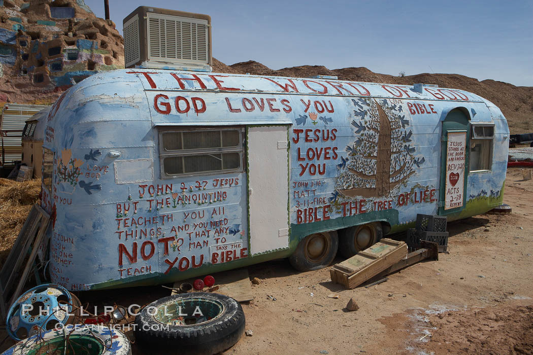 Salvation Mountain, near the desert community of Slab City and the small town of Niland on the east side of the Salton Sea.  Built over several decades by full-time resident Leonard Knight, who lives at the site, Salvation Mountain was built from over 100,000 gallons of paint, haybales, wood and metal and was created by Mr. Knight to convey the message that "God Loves Everyone". California, USA, natural history stock photograph, photo id 22509