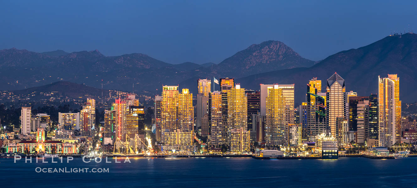 San Diego City Skyline at Sunset, viewed from Point Loma, panoramic photograph. The mountains east of San Diego can be clearly seen when the air is cold, dry and clear as it is in this photo. Lyons Peak is in center and the flanks of Mount San Miguel to the right San Diego City Skyline at Sunset, viewed from Point Loma, panoramic photograph. The mountains east of San Diego can be clearly seen when the air is cold, dry and clear as it is in this photo. Lyons Peak is in center and the flanks of Mount San Miguel to the right
