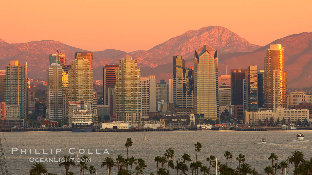 San Diego city skyline, showing the buildings of downtown San Diego rising above San Diego Harbor, viewed from Point Loma at sunset, with mountains of the Cleveland National Forest rising in the distance. California, USA, natural history stock photograph, photo id 22251