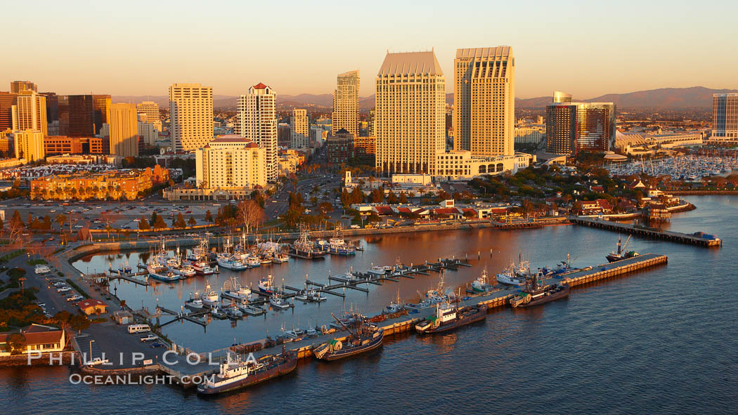 San Diego Marina District, sunset, with fishing vessels docked alongside pier, Seaport Village (right) and downtown highrise office buildings rising over San Diego Bay. California, USA, natural history stock photograph, photo id 22404