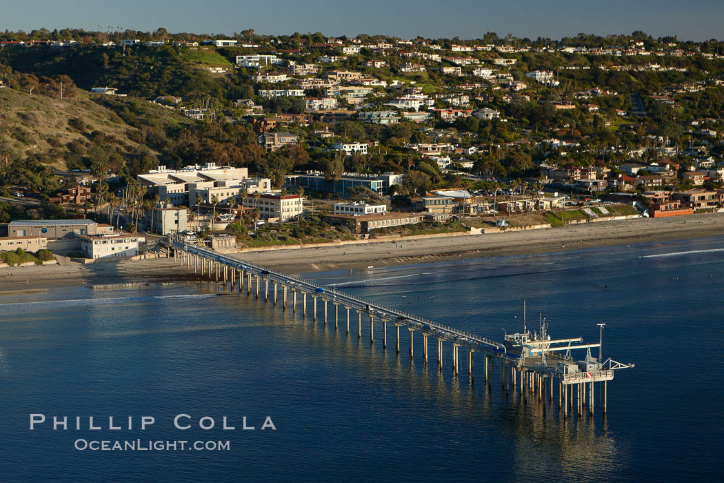 SIO Pier.  The Scripps Institution of Oceanography research pier is 1090 feet long and was built of reinforced concrete in 1988, replacing the original wooden pier built in 1915. The Scripps Pier is home to a variety of sensing equipment above and below water that collects various oceanographic data. The Scripps research diving facility is located at the foot of the pier. Fresh seawater is pumped from the pier to the many tanks and facilities of SIO, including the Birch Aquarium. The Scripps Pier is named in honor of Ellen Browning Scripps, the most significant donor and benefactor of the Institution. La Jolla, California, USA, natural history stock photograph, photo id 22313