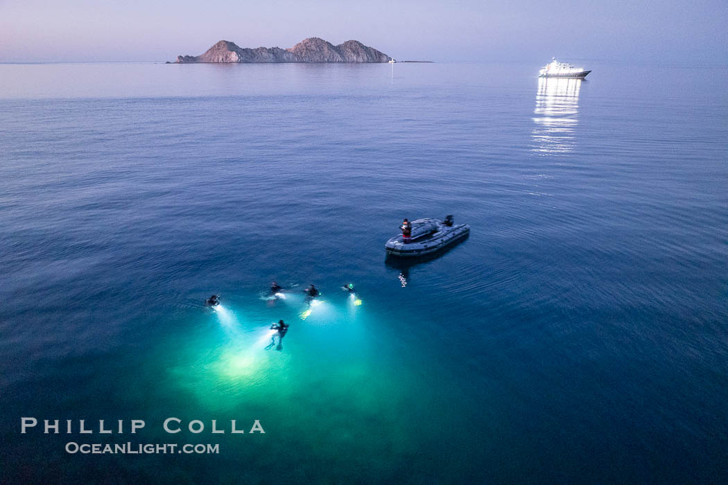 SCUBA Divers at Night, Isla de la Guarda Island, aerial photo, Sea of Cortez. Dive boat Rocio del Mar is seen in the distance. Night diving is scary so I stay on the big boat and fly my drone, Isla Angel de la Guarda, Baja California, Mexico SCUBA Divers at Night, Isla de la Guarda Island, aerial photo, Sea of Cortez. Dive boat Rocio del Mar is seen in the distance. Night diving is scary so I stay on the big boat and fly my drone, Isla Angel de la Guarda, Baja California, Mexico
