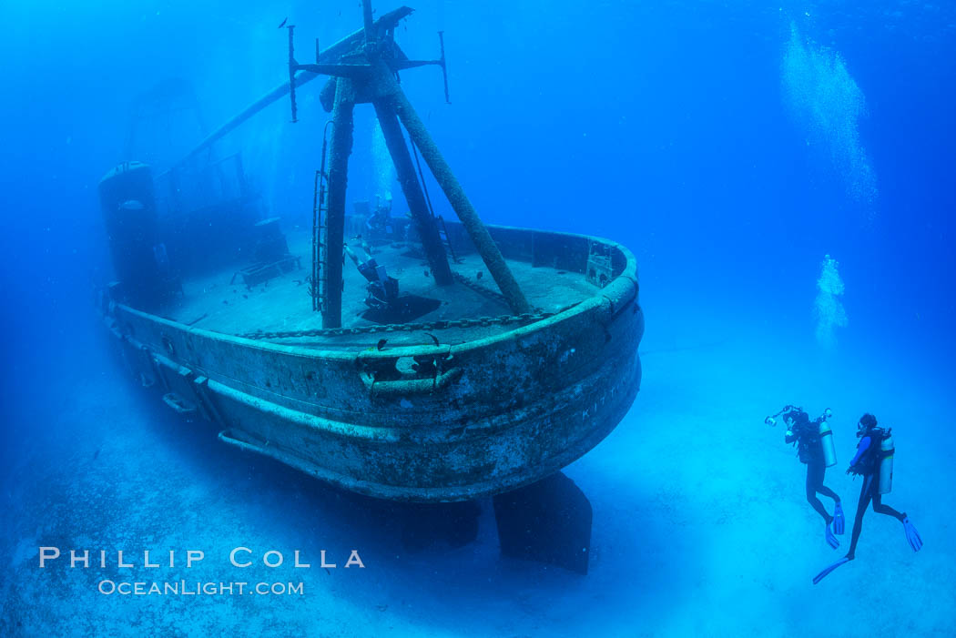 SCUBA divers on the wreck of the USS Kittiwake, sunk off Seven Mile Beach on Grand Cayman Island to form an underwater marine park and dive attraction. Cayman Islands, natural history stock photograph, photo id 32148