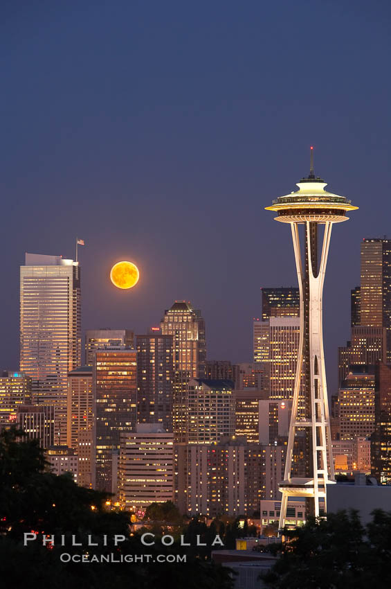 Full moon rises over Seattle city skyline, Space Needle at right. Washington, USA, natural history stock photograph, photo id 13664