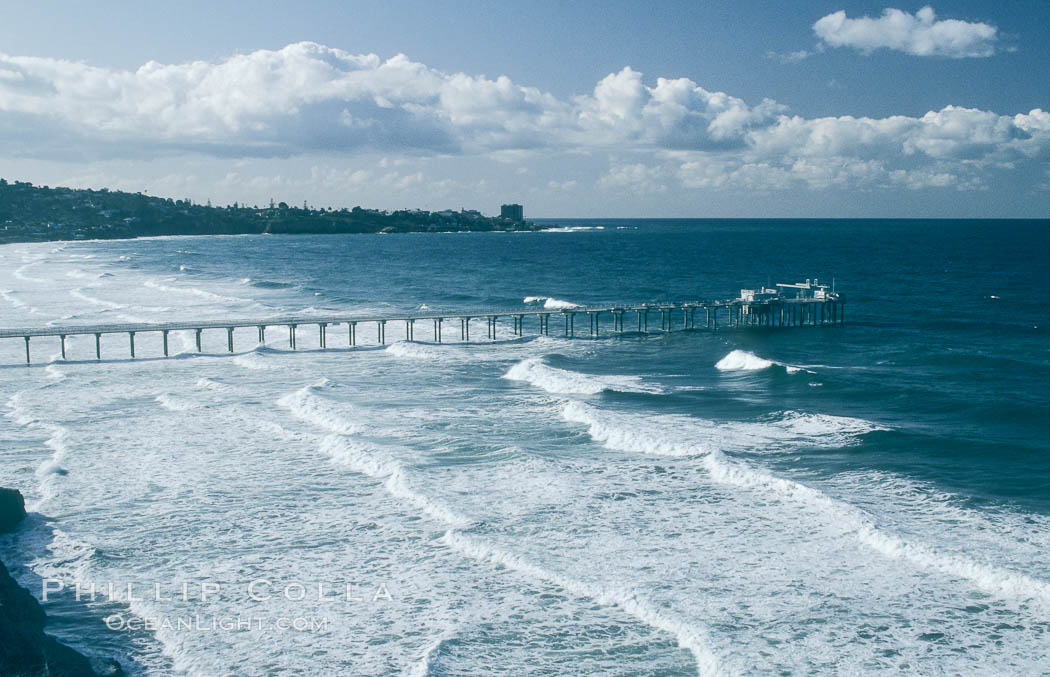 Scripps Institution of Oceanography research piers extends out beyond the waves, with La Jolla in the distance. California, USA, natural history stock photograph, photo id 18714