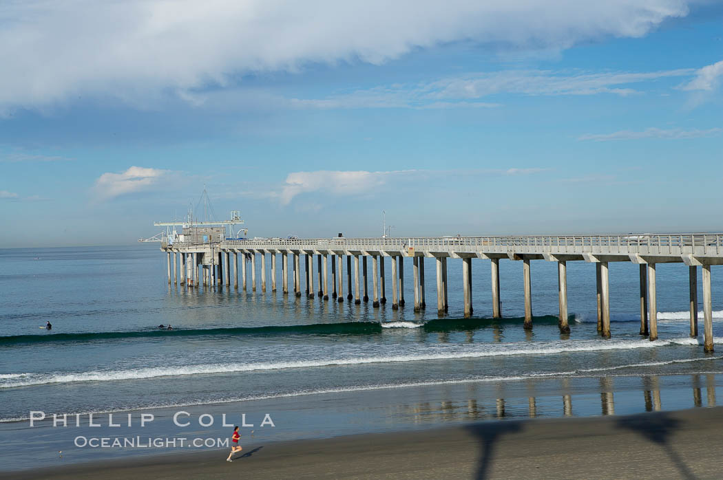The Scripps Institution of Oceanography research pier is 1090 feet long and was built of reinforced concrete in 1988, replacing the original wooden pier built in 1915.  The Scripps Pier is home to a variety of sensing equipment above and below water that collects various oceanographic data.  The Scripps research diving facility is located at the foot of the pier.  Fresh seawater is pumped from the pier to the many tanks and facilities of SIO, including the Birch Aquarium.  The Scripps Pier is named in honor of Ellen Browning Scripps, the most significant donor and benefactor of the Institution. La Jolla, California, USA, natural history stock photograph, photo id 14749