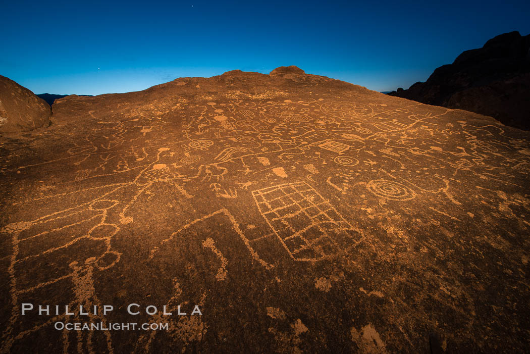 Sky Rock at night, light by moonlight with stars in the clear night sky above.  Sky Rock petroglyphs near Bishop, California. Hidden atop an enormous boulder in the Volcanic Tablelands lies Sky Rock, a set of petroglyphs that face the sky. These superb examples of native American petroglyph artwork are thought to be Paiute in origin, but little is known about them., natural history stock photograph, photo id 28502