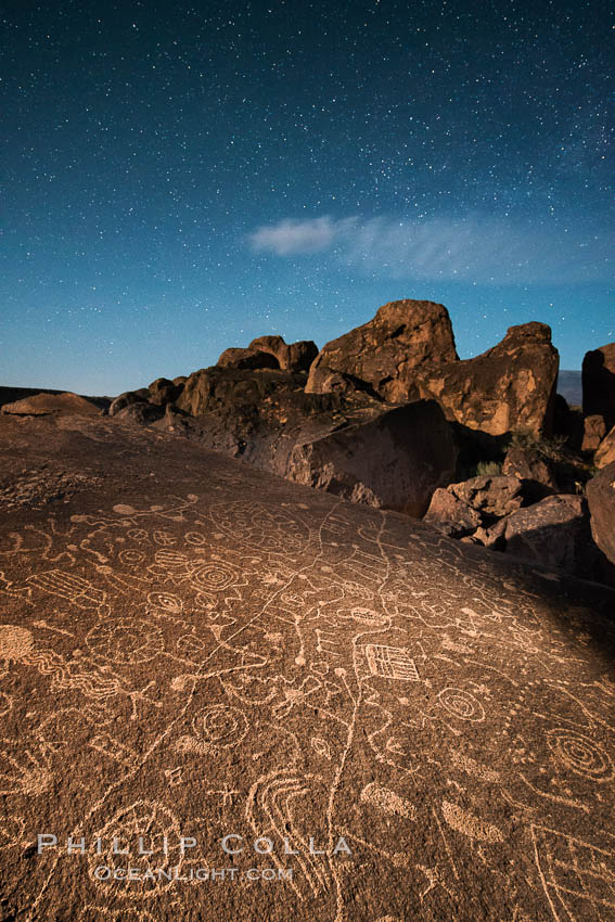 Sky Rock at night, light by moonlight with stars in the clear night sky above.  Sky Rock petroglyphs near Bishop, California. Hidden atop an enormous boulder in the Volcanic Tablelands lies Sky Rock, a set of petroglyphs that face the sky. These superb examples of native American petroglyph artwork are thought to be Paiute in origin, but little is known about them., natural history stock photograph, photo id 28506