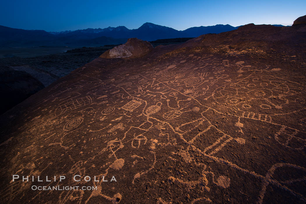 Sky Rock at night, light by moonlight with stars in the clear night sky above.  Sky Rock petroglyphs near Bishop, California. Hidden atop an enormous boulder in the Volcanic Tablelands lies Sky Rock, a set of petroglyphs that face the sky. These superb examples of native American petroglyph artwork are thought to be Paiute in origin, but little is known about them., natural history stock photograph, photo id 28500