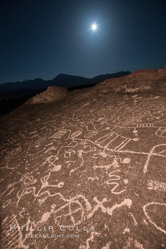 Sky Rock at night, light by moonlight with stars in the clear night sky above.  Sky Rock petroglyphs near Bishop, California. Hidden atop an enormous boulder in the Volcanic Tablelands lies Sky Rock, a set of petroglyphs that face the sky. These superb examples of native American petroglyph artwork are thought to be Paiute in origin, but little is known about them., natural history stock photograph, photo id 28504