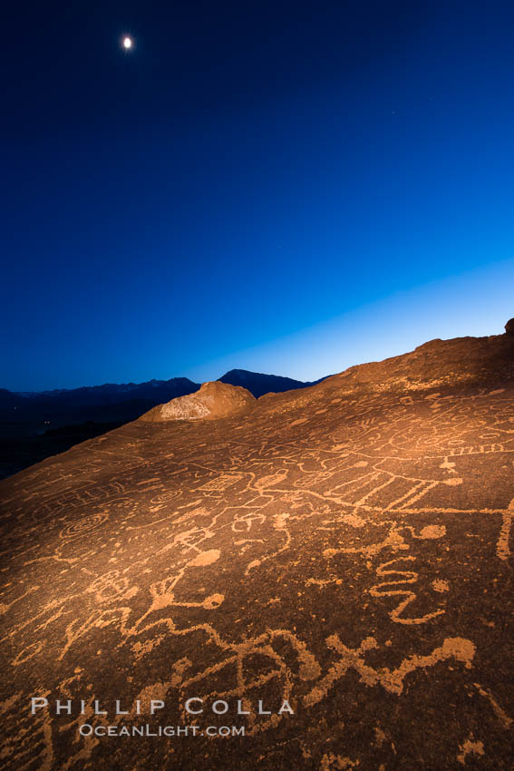 Sky Rock at night, light by moonlight with stars in the clear night sky above.  Sky Rock petroglyphs near Bishop, California. Hidden atop an enormous boulder in the Volcanic Tablelands lies Sky Rock, a set of petroglyphs that face the sky. These superb examples of native American petroglyph artwork are thought to be Paiute in origin, but little is known about them., natural history stock photograph, photo id 28501