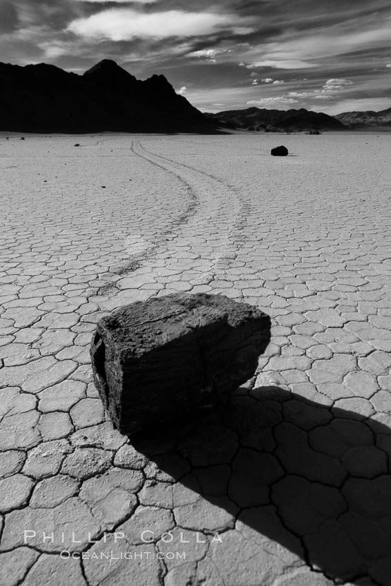 A sliding rock of the Racetrack Playa.  The sliding rocks, or sailing stones, move across the mud flats of the Racetrack Playa, leaving trails behind in the mud.  The explanation for their movement is not known with certainty, but many believe wind pushes the rocks over wet and perhaps icy mud in winter. Death Valley National Park, California, USA, natural history stock photograph, photo id 25334