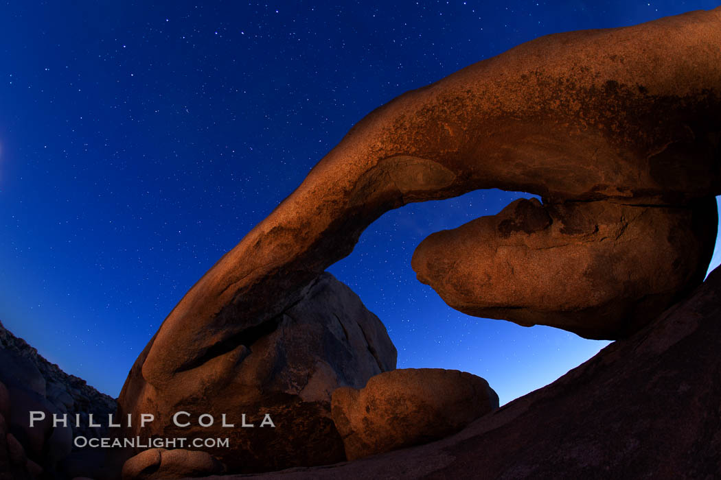 Star trails and Arch Rock. Polaris, the North Star, is at the center of the circular arc star trails as they pass above this natural stone archway in Joshua Tree National Park., natural history stock photograph, photo id 27707