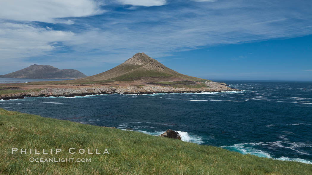 Steeple Jason Island, southwestern exposure, looking south pass the isthmus toward the southern half of the island.  Steeple Jason is one of the remote Jason Group of Islands in the West Falklands.  Uninhabited, the island is spectacular both for its rugged scenery and its enormous breeding colony of black-browed albatross.  Steeple Jason Island is now owned and administered by the Wildlife Conservation Society. Falkland Islands, United Kingdom, natural history stock photograph, photo id 24209