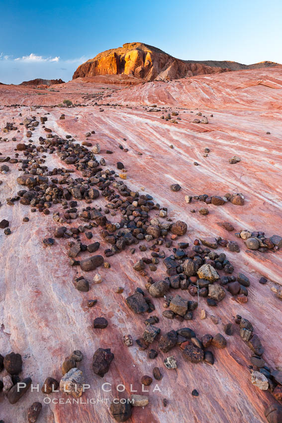 Stones, striated sandstone and sunset light on nearby butte. Valley of Fire State Park, Nevada, USA, natural history stock photograph, photo id 26633