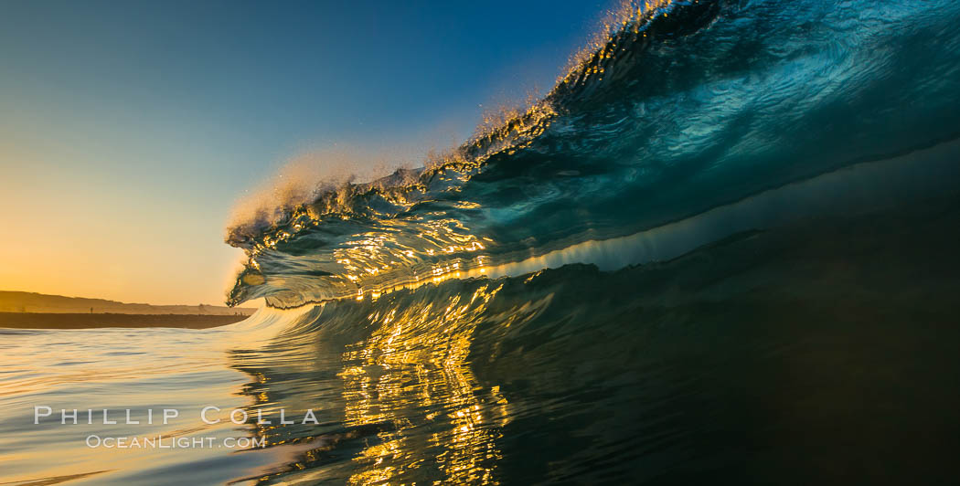 Sunrise glints yellow on breaking wave, dawn surf, The Wedge, Newport Beach, California Sunrise glints yellow on breaking wave, dawn surf, The Wedge, Newport Beach, California