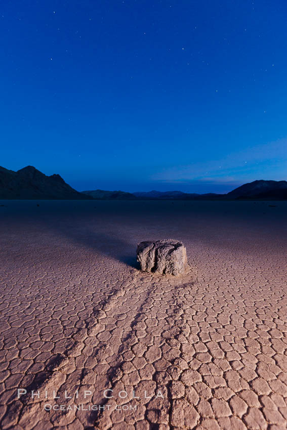 Sunrise on the Racetrack Playa. The sliding rocks, or sailing stones, move across the mud flats of the Racetrack Playa, leaving trails behind in the mud. The explanation for their movement is not known with certainty, but many believe wind pushes the rocks over wet and perhaps icy mud in winter. Death Valley National Park, California, USA, natural history stock photograph, photo id 27694