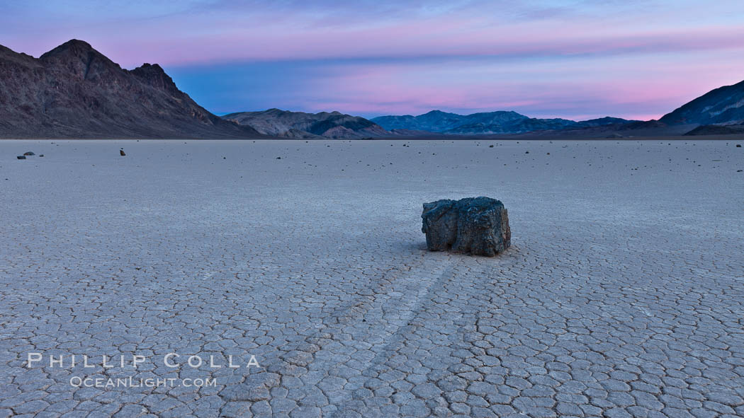 Sunrise on the Racetrack Playa. The sliding rocks, or sailing stones, move across the mud flats of the Racetrack Playa, leaving trails behind in the mud. The explanation for their movement is not known with certainty, but many believe wind pushes the rocks over wet and perhaps icy mud in winter. Death Valley National Park, California, USA, natural history stock photograph, photo id 27698