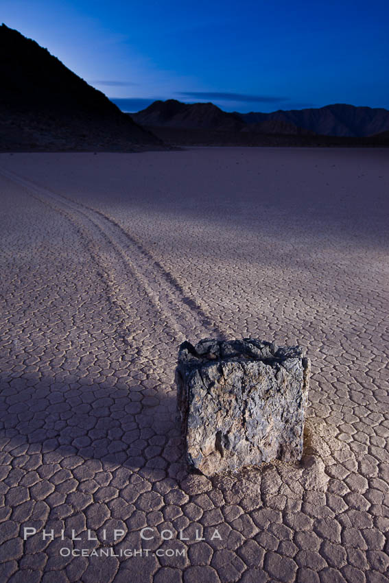 Sunrise on the Racetrack Playa. The sliding rocks, or sailing stones, move across the mud flats of the Racetrack Playa, leaving trails behind in the mud. The explanation for their movement is not known with certainty, but many believe wind pushes the rocks over wet and perhaps icy mud in winter. Death Valley National Park, California, USA, natural history stock photograph, photo id 27696