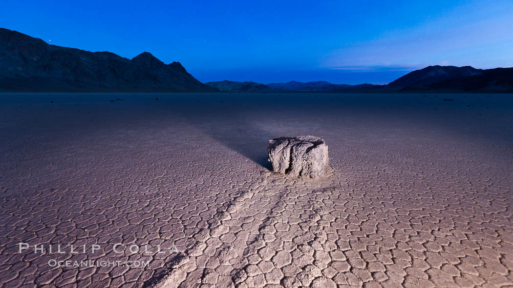 Sunrise on the Racetrack Playa. The sliding rocks, or sailing stones, move across the mud flats of the Racetrack Playa, leaving trails behind in the mud. The explanation for their movement is not known with certainty, but many believe wind pushes the rocks over wet and perhaps icy mud in winter. Death Valley National Park, California, USA, natural history stock photograph, photo id 27695