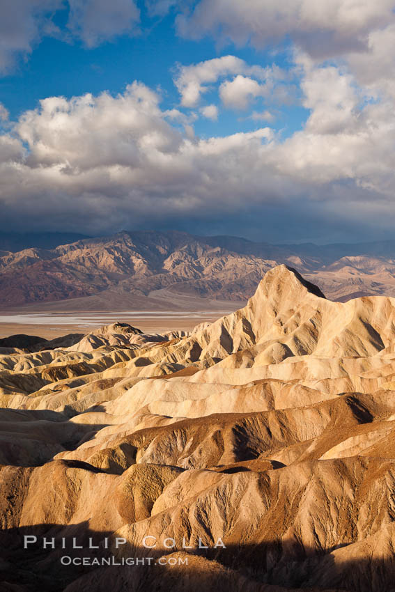 Sunrise at Zabriskie Point, Manly Beacon is lit by the morning sun while clouds from a clearing storm pass by. Death Valley National Park, California, USA, natural history stock photograph, photo id 27666