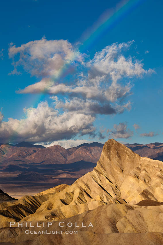 Sunrise at Zabriskie Point, Manly Beacon is lit by the morning sun while clouds from a clearing storm pass by. Death Valley National Park, California, USA, natural history stock photograph, photo id 27663