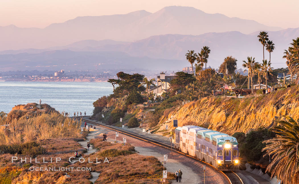 Sunset on the Del Mar Bluffs and Train Tracks, with North County coastline. The highest peaks in the distance are Santiago Peak and Modjeska Peak, the pair commonly known as Saddleback