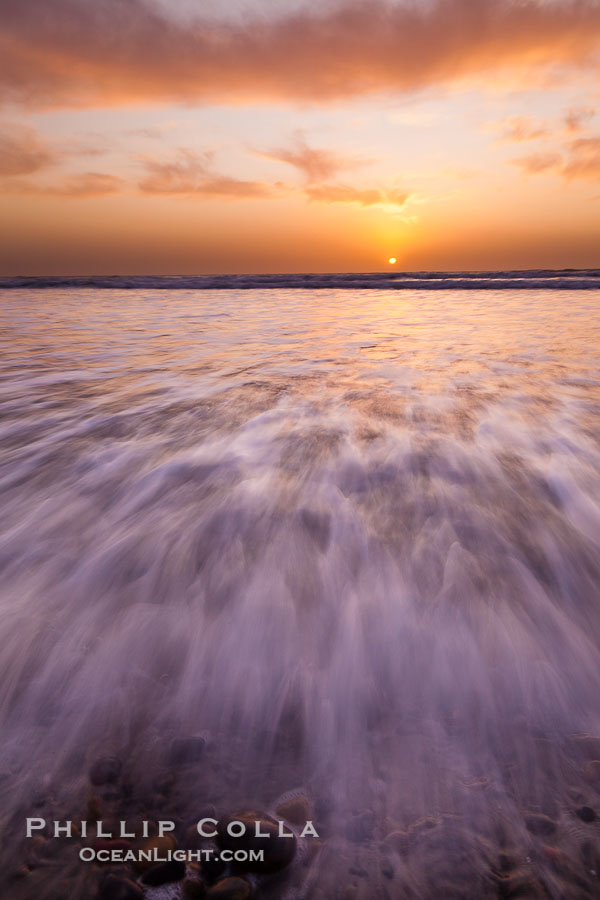 Sunset and incoming surf, gorgeous colors in the sky and on the ocean at dusk, the incoming waves are blurred in this long exposure., natural history stock photograph, photo id 27163