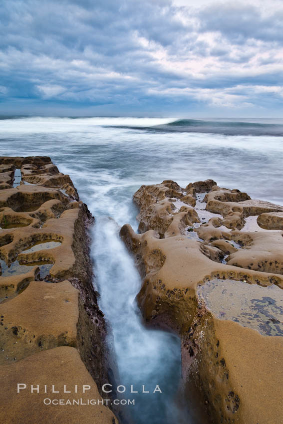 Waves wash over sandstone reef, clouds and sky. La Jolla, California, USA, natural history stock photograph, photo id 26336