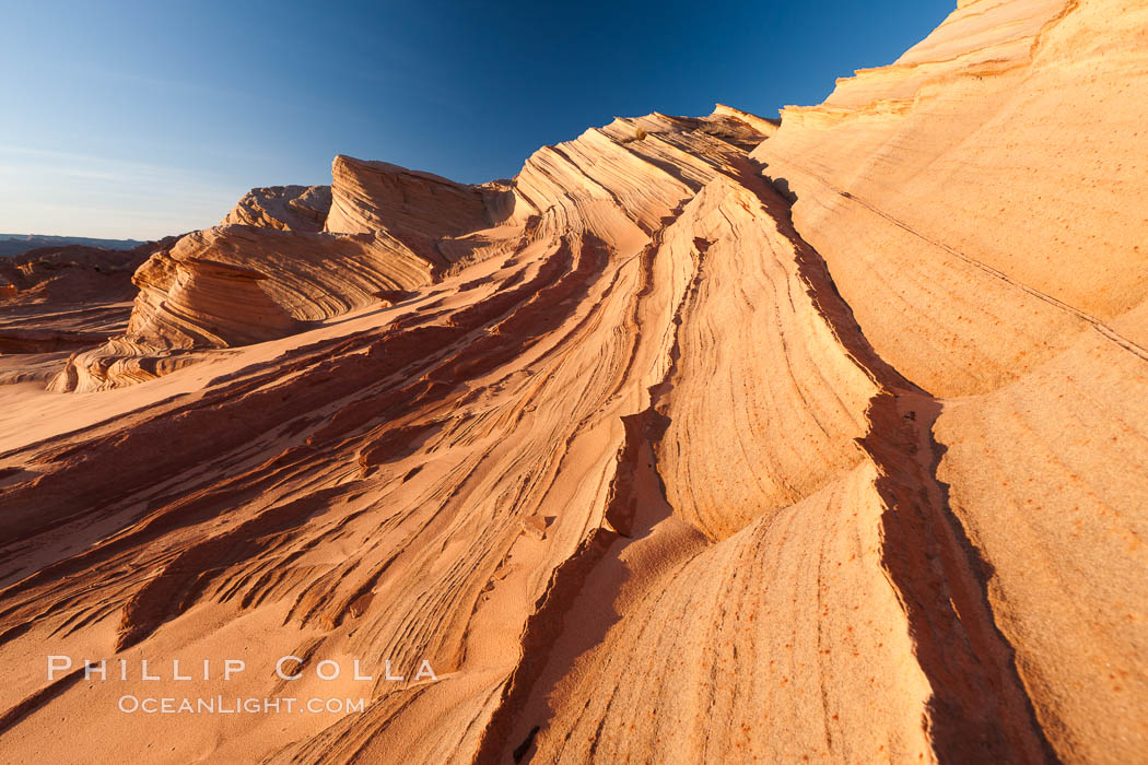 Sandstone "fins", eroded striations that depict how sandstone -- ancient compressed sand -- was laid down in layers over time.  Now exposed, the layer erode at different rates, forming delicate "fins" that stretch for long distances. Navajo Tribal Lands, Page, Arizona, USA, natural history stock photograph, photo id 26646